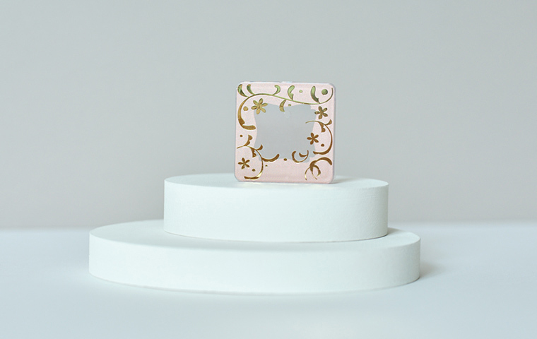 手で触れられない全面印刷容器を自動で持ち上げて搬送する小型コンベアを開発。生産性向上により短納期とコスト削減を実現